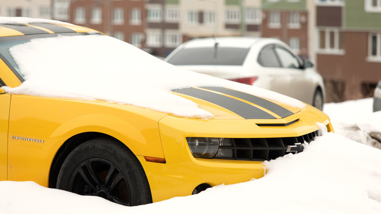 Front side of sporty car Chevrolet Camaro waiting for spring like snowdrop Omsk, Russia, 29.02.2020