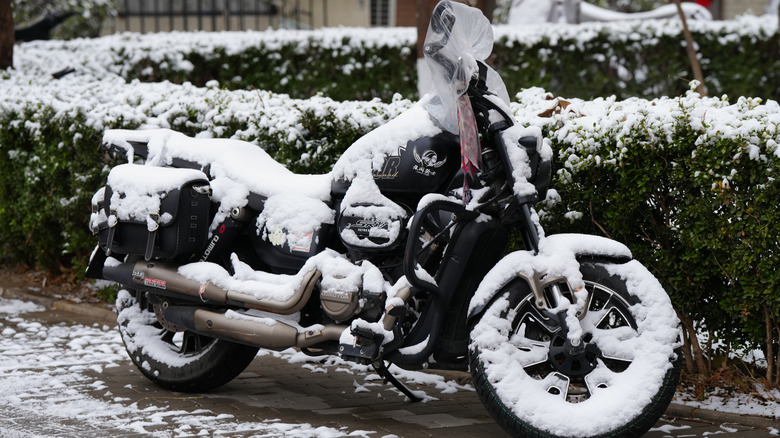BEIJING, CHINA - MARCH 05: A motorcycle parked spring dusting of snow on March 5, 2026 in Beijing, China. From 09:00 on the 4th to 07:00 on the 5th, the citywide average snowfall was 5.6 millimeters, with an urban average of 5.3 millimeters.(Photo by Fred Lee/Getty Images)