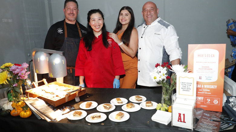 OCTOBER 19: (R) Chef Max Calicchio and his team pose for photos during Steak & Whiskey presented by A.1. Sauce hosted by Robert Irvine during Food Network New York City Wine & Food Festival presented by Invesco QQQ at Hall Des Lumieres on October 19, 2024 in New York City. (Photo by Astrid Stawiarz/Getty Images for NYCWFF)