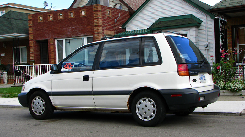 A white Plymouth Colt Vista parked on a residential street
