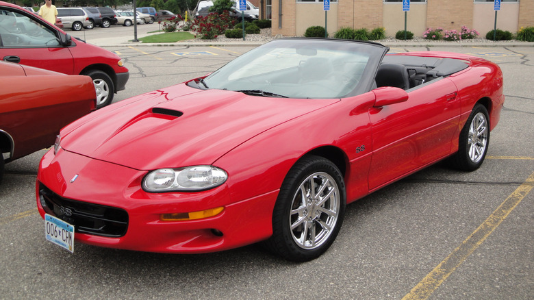 A red Chevrolet Camaro in a parking lot