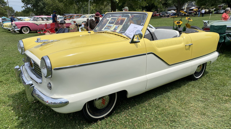 A yellow and white 1956 Nash Metropolitan