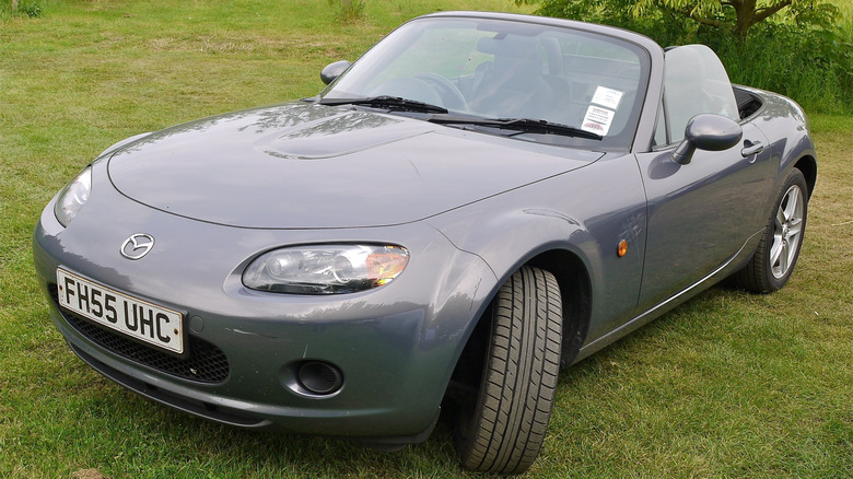 A dark gray Mazda MX5