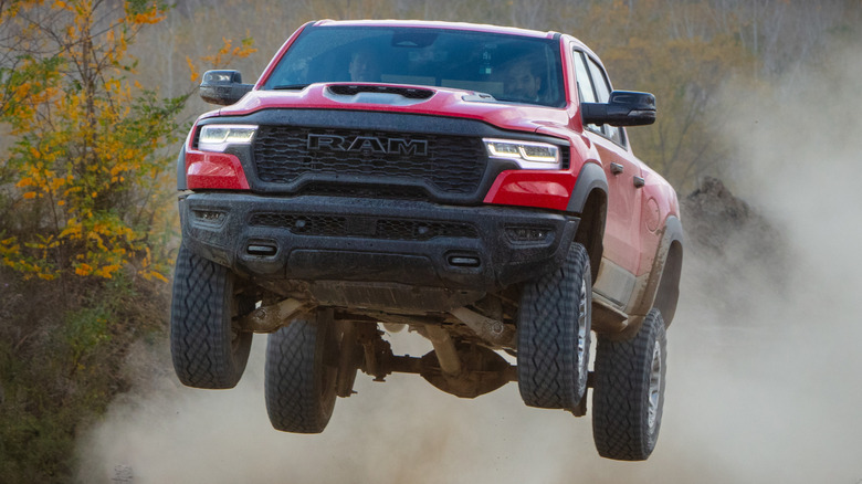 The 2024 Ram 1500 RHO fitted with Hurricane inline-six getting air on a dirt road