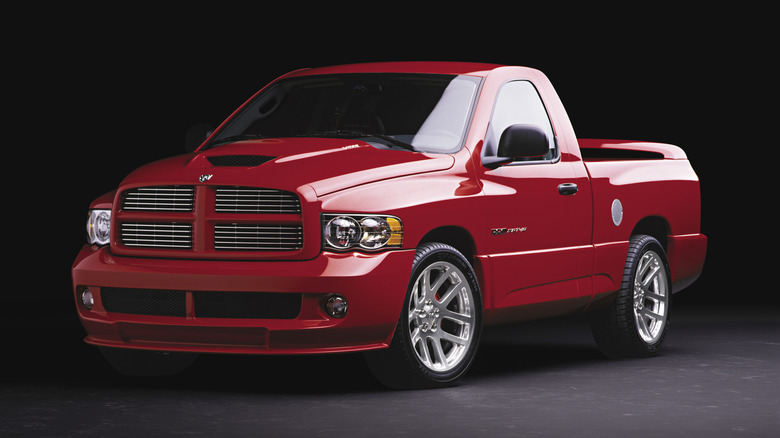 A red 2005 Dodge Ram SRT-10 pickup truck in a dark studio