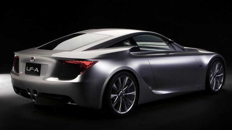 A slver Lexus LFA coupe in a dark studio