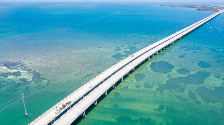 Aerial point of view of the Florida Keys oversea highway bridge crossing from island to island through a turquoise sea.