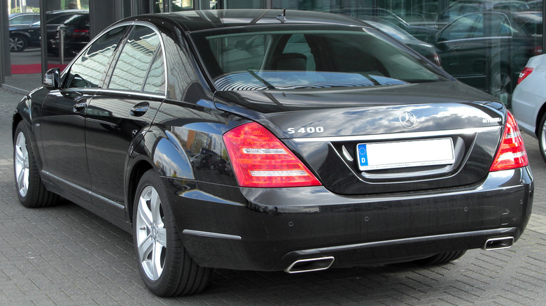A rear 3/4 view of a black W221 Mercedes-Benz S400 Hybrid