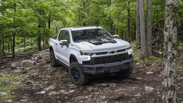 Front view of a 2024 Chevy Silverado ZR2 Bison off-roading through the woods