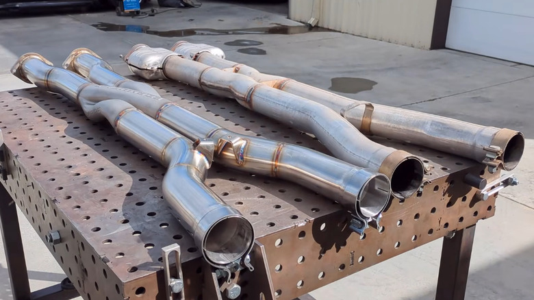 Pipes resting on a fabrication table.