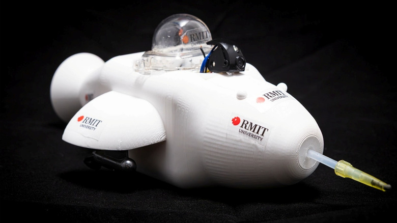 A little white spaceship-looking device with a camera and a bubble up top. This is the "Electronic Dolphin" designed by RMIT University to "hoover up" oil spilled in bodies of water.