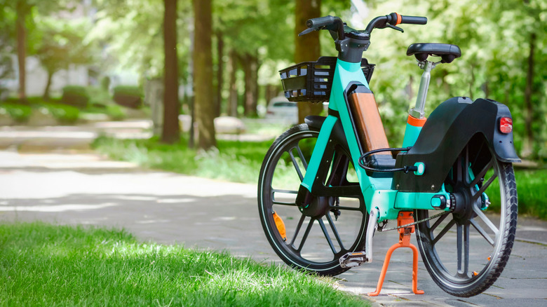 Bike Share Rent in City Street. Bicycle sharing service. Electric bike in urban environment. Electro e bike as Public Transport in Green City in Germany.