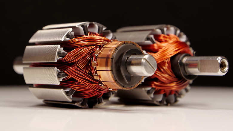 Two electric motors, featuring their copper wire coils and magnets.