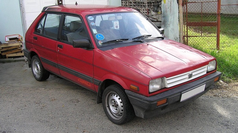 Red first-generation Subaru Justy.