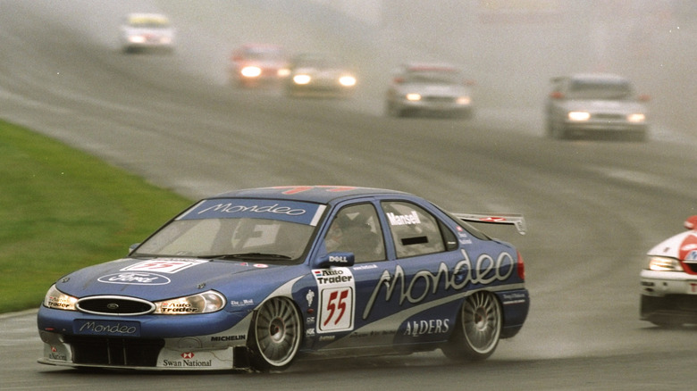 A ford Mondeo BTCC race car in the rain driven by Nigel Mansell.