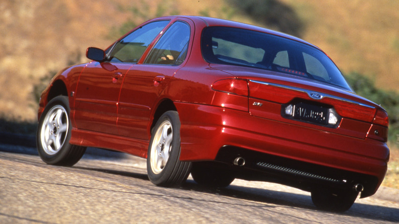 A press image of a red Ford SVT Contour being driven hard on the road.