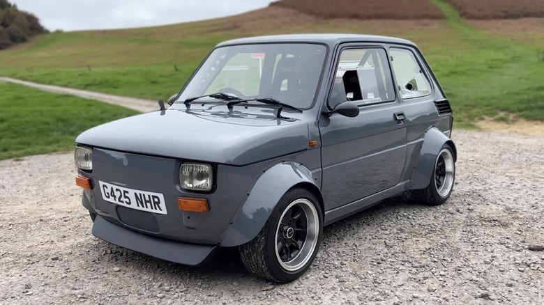 A Fiat 126 with a BMW K75 engine, huge fender flares, and a ton of custom work