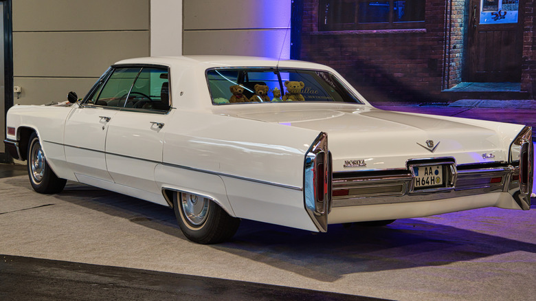 A white 1966 Cadillac DeVille parked inside.