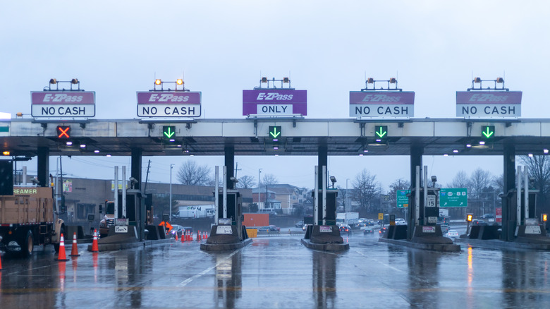 Empty E-ZPass toll stalls connected a rainy day.