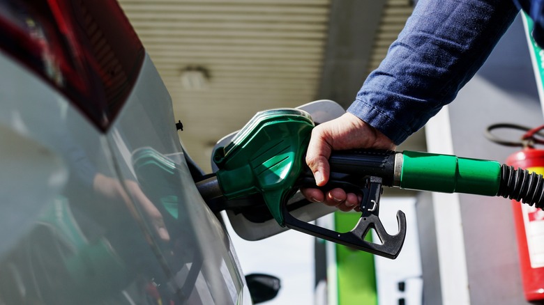 A person filling their car with diesel fuel.