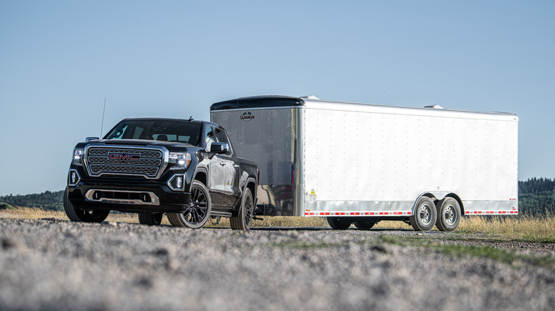 A gray 2021 GMC Sierra 1500 pulling a trailer.