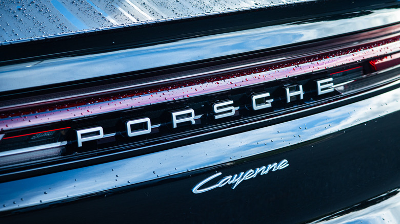 A close-up of Porsche Cayenne rear script and badge