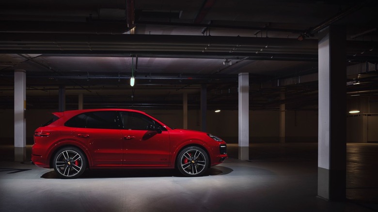 A side photo of a red 2021 Porsche Cayenne GTS parked in an underground carpark