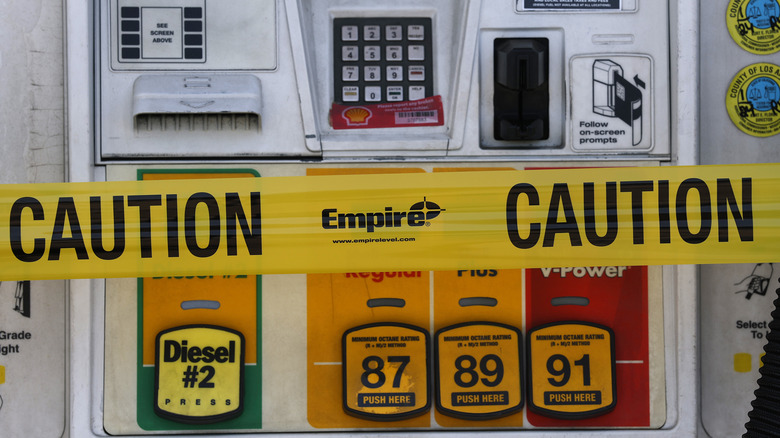 Caution tape on a Shell fuel pump
