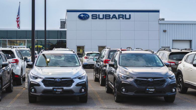 A Subaru dealership building in Yorkville, New York, with new Subaru cars in the foreground.