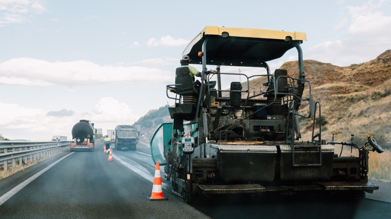 Asphalt paver resurfacing a highway