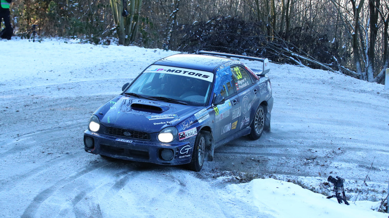 A Subaru WRX rally car drifting around a corner