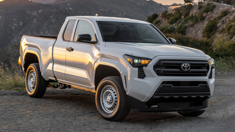 3/4 front shot of a gray 2025 Toyota Tacoma SR with mountains in the background