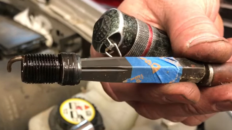 A threaded shell being extracted with the use of an extraction tool.