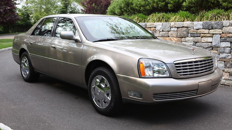 A 2004 Cadillac DeVille armored variant in gray-gold.