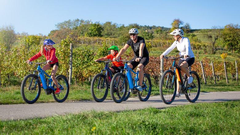 A family riding e-bikes