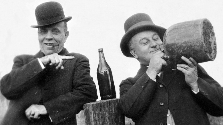 Two guys drinking moonshine