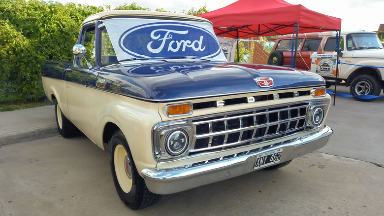 A blue and white 1963 Ford F100 pickup