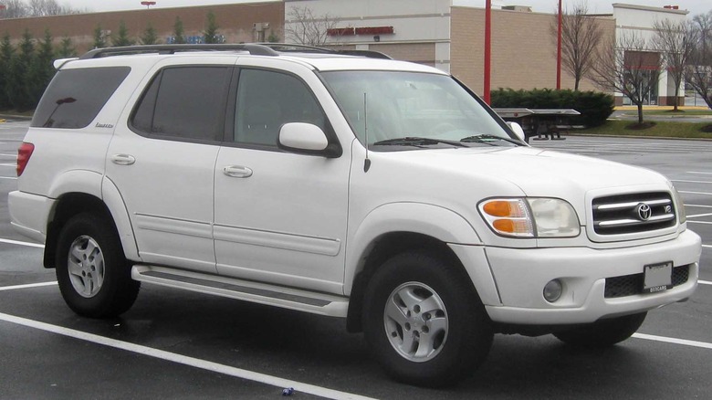 White 2002 Toyota Sequoia parked in a parking lot on a cloudy winter day.