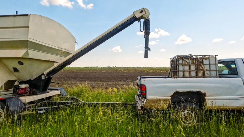 A pickup truck towing farm equipment