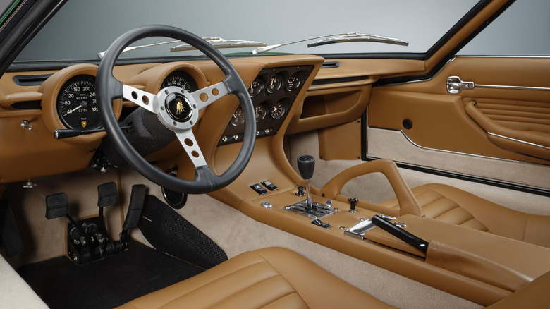 The tan and beige interior of a Lamborghini Miura