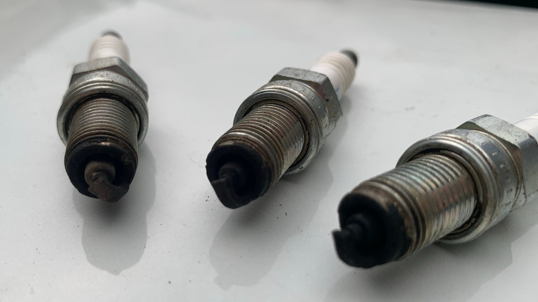 Used spark plugs with severe carbon buildup