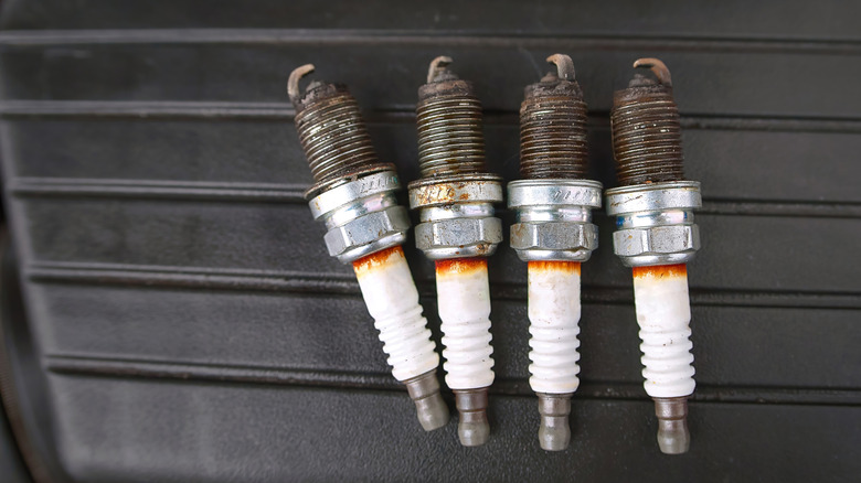 A group of soiled and utilized plugs connected apical of nan motor cover