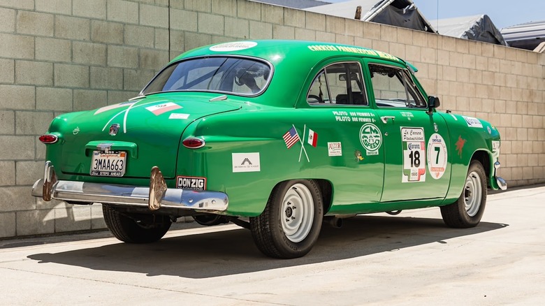 Rear 3/4 view of a green 1950 Ford Standard Sedan Carrera Panamericana race car up for auction