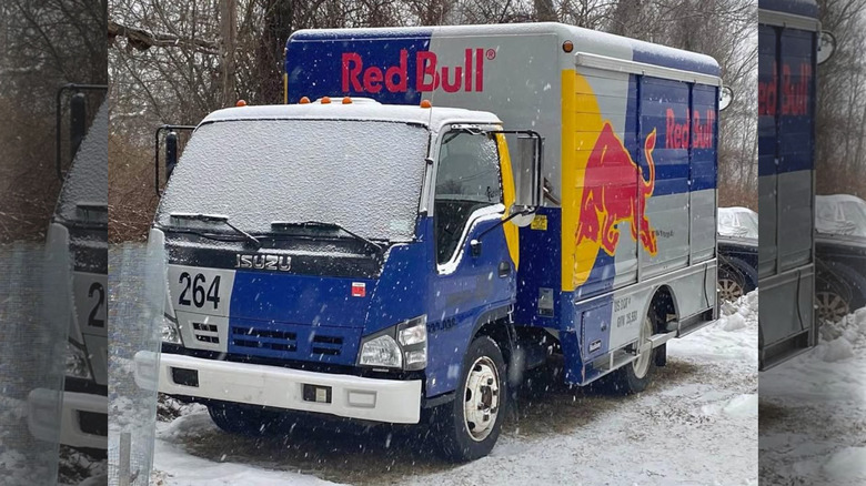 An Isuzu box truck in Red Bull livery.