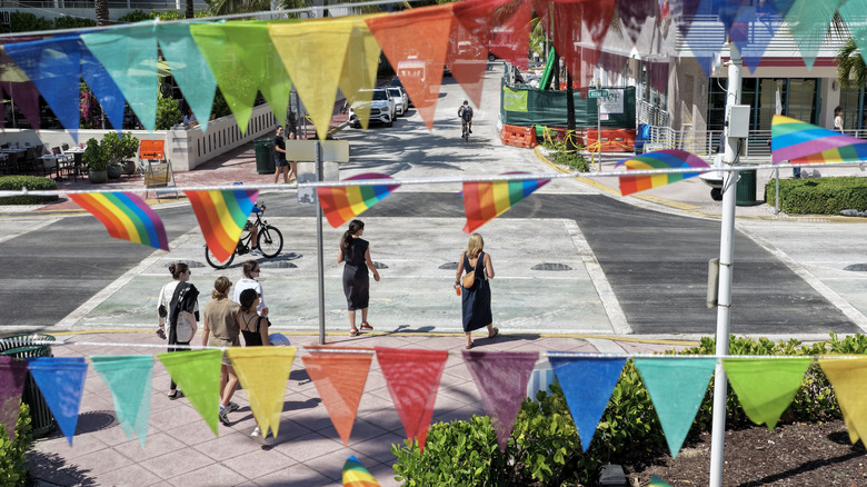 MIAMI BEACH, FLORIDA - OCTOBER 06: In an aerial view, pride flags fly near the intersection where the Florida Department of Transportation removed the LGBTQ+ rainbow paver crosswalk and replaced it with black pavement on October 6, 2025, in Miami Beach, Florida. The removal, which took place on Sunday, follows the FDOT's order to local governments to remove any pavement featuring social, political, or ideological messages. (Photo by Joe Raedle/Getty Images)
