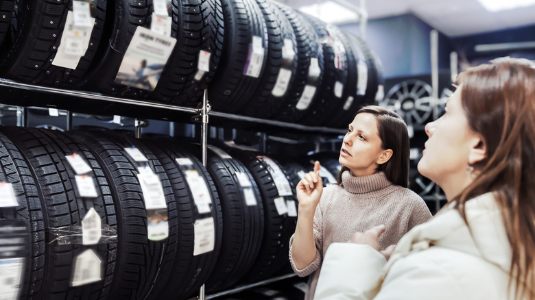 Two women shopping for tires in a store