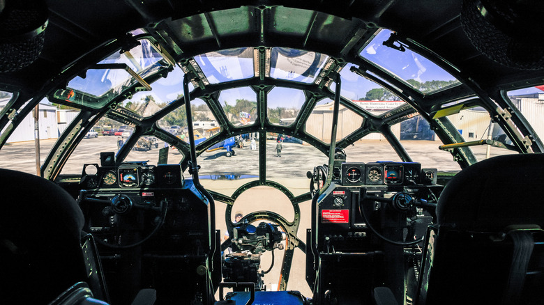 The cockpit view of a B-29 Superfortress as it sits on an airfield