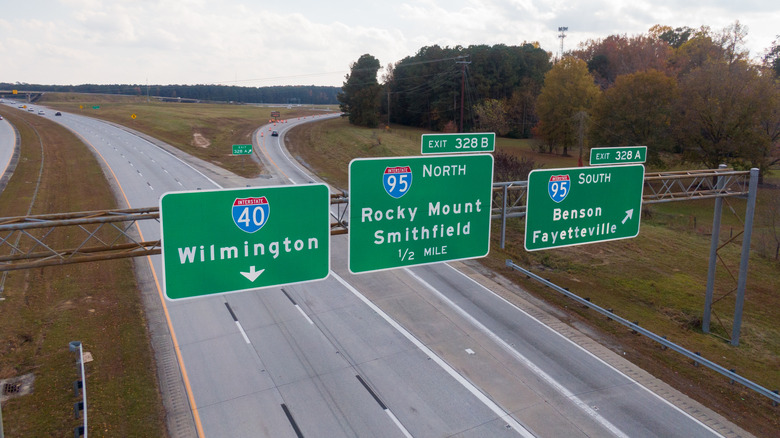 An overhead, high-angle aerial drone shot capturing the main line of Interstate 40 (I-40) looking east towards the junction with Interstate 95 (I-95).