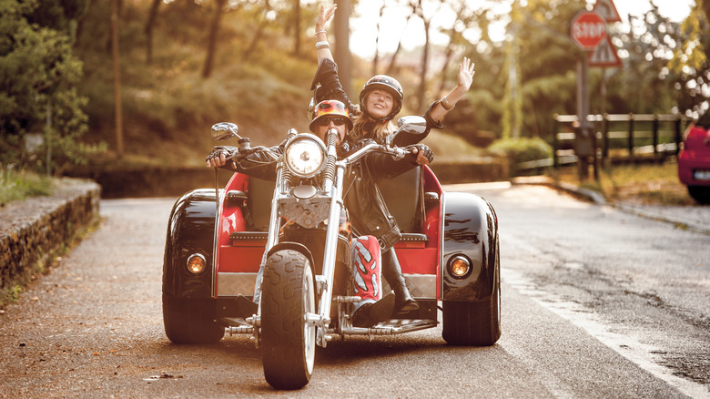 A mates riding a three-wheeled motorcycle