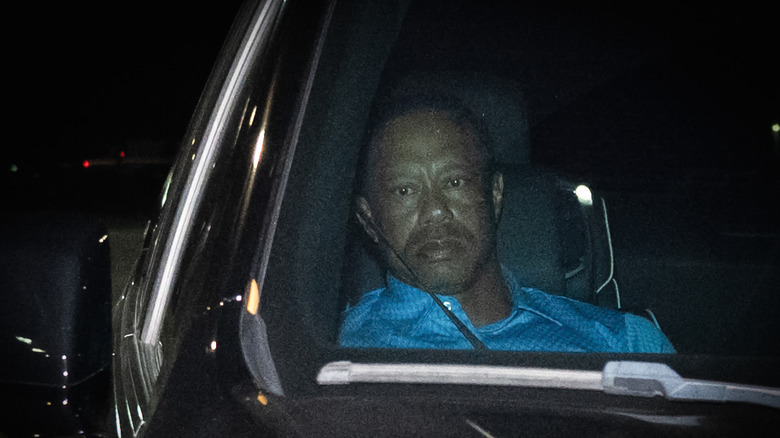 Tiger Woods in the passenger seat of an SUV after his March 2026 arrest.
